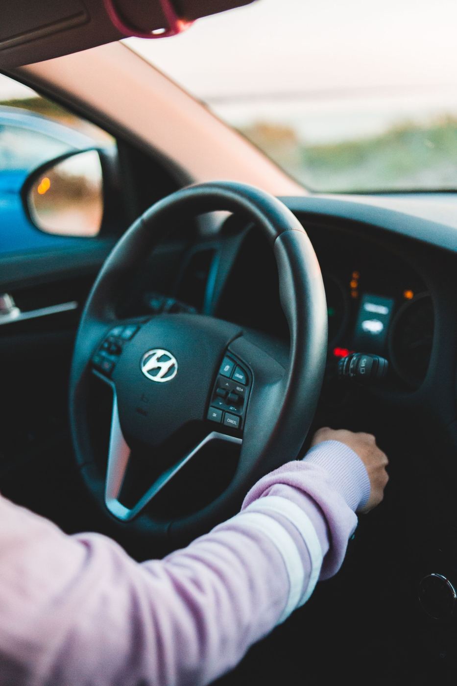 Driver starting a car, representing everyday driving after a minor collision