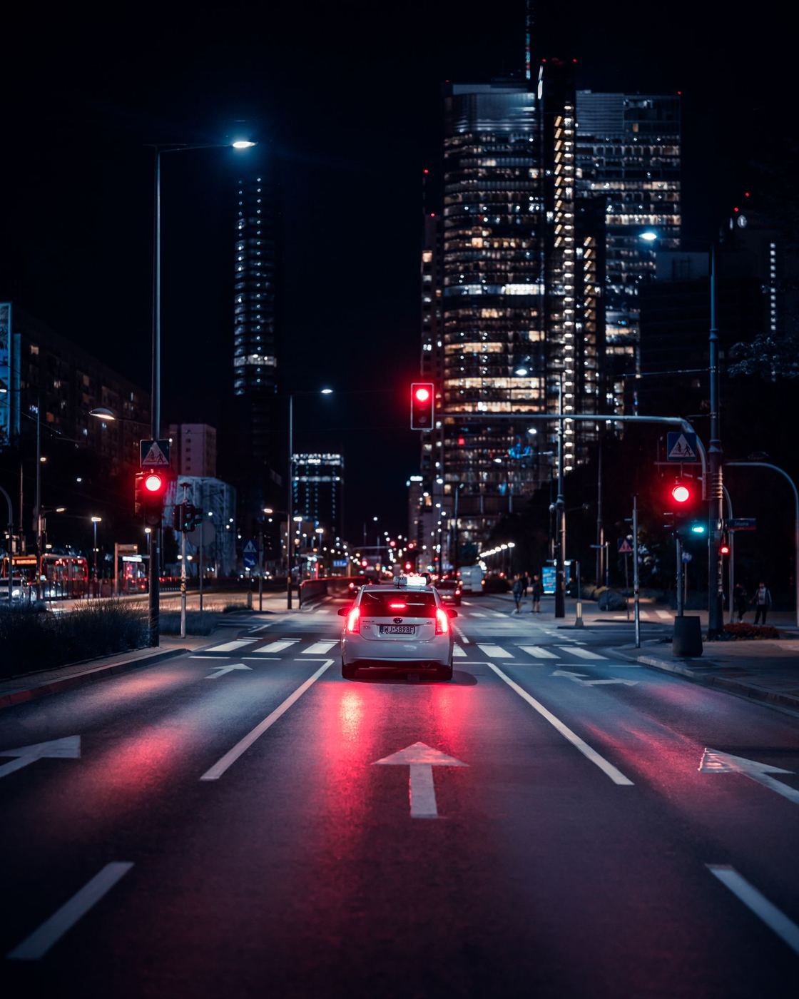 Car stopped at a traffic light at night, illustrating rear-end collision risk