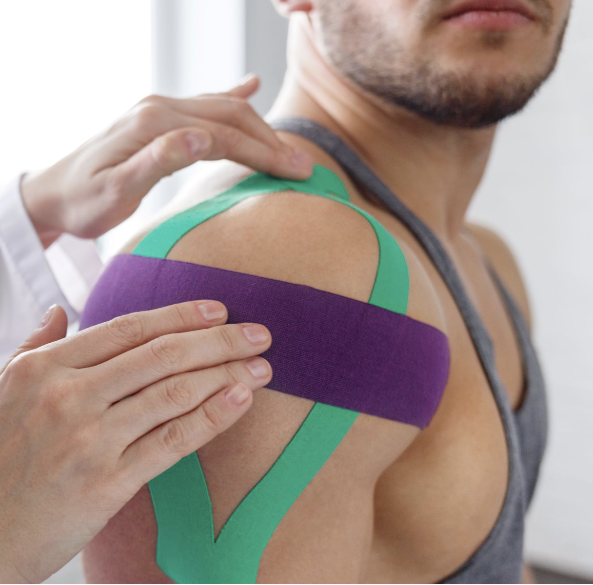 Kinesiology taping applied to shoulder for injury support and recovery